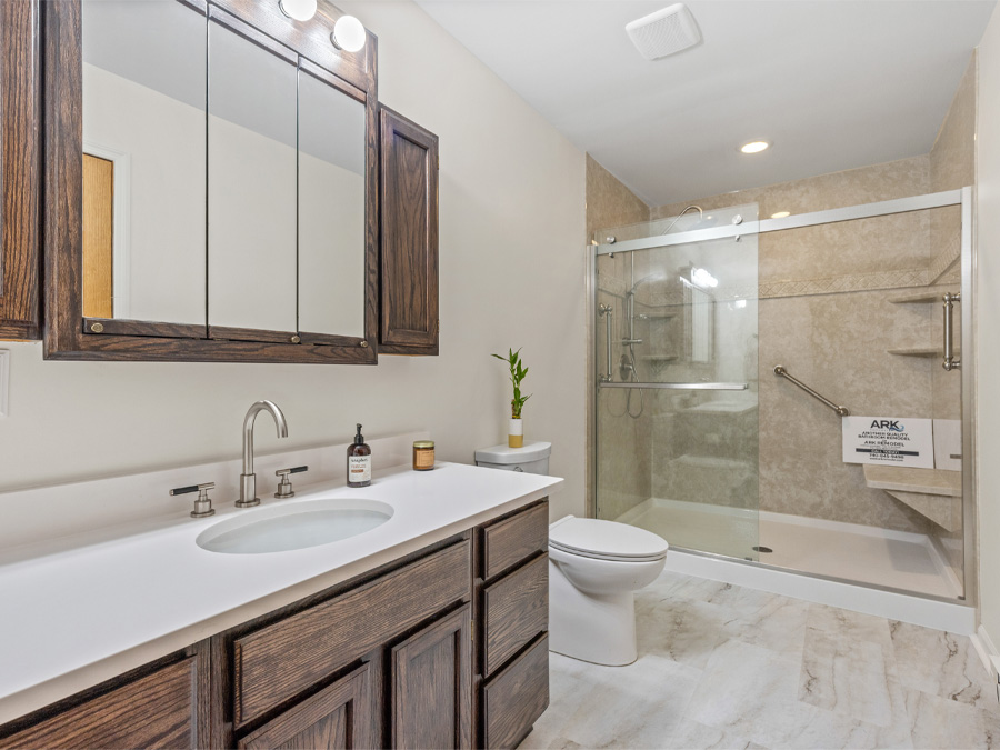 Completed full bathroom remodel showing vanity, floor tile, and shower